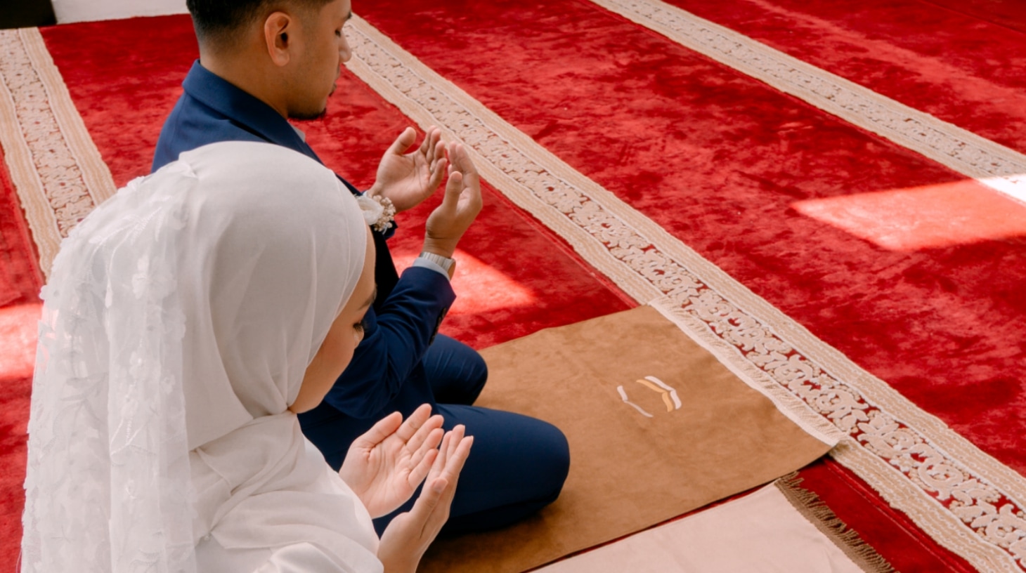 Wanita berdoa menggunakan mukena dan sajadah premium Zachyra